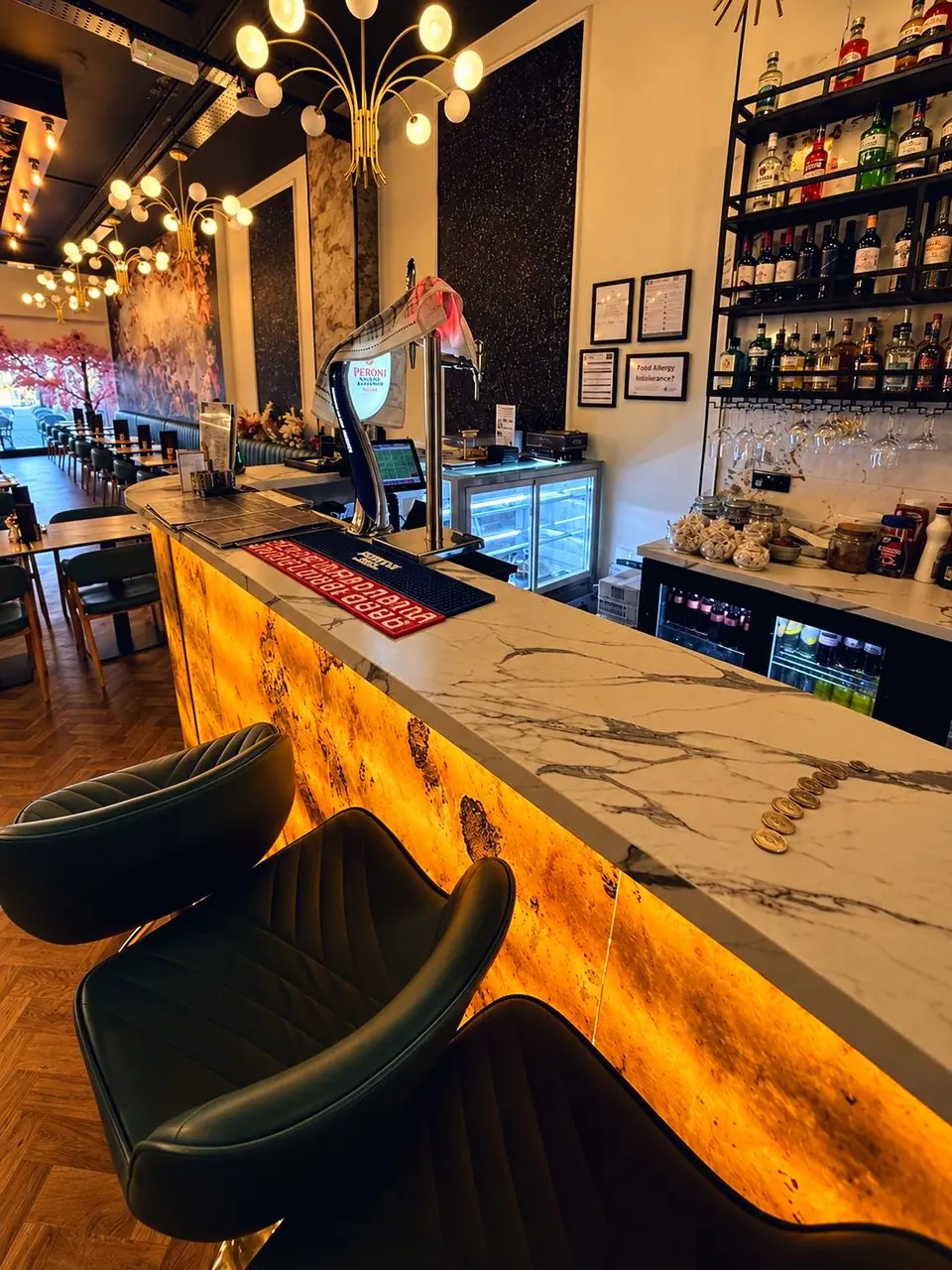 The marble counter and the bar's gold stools