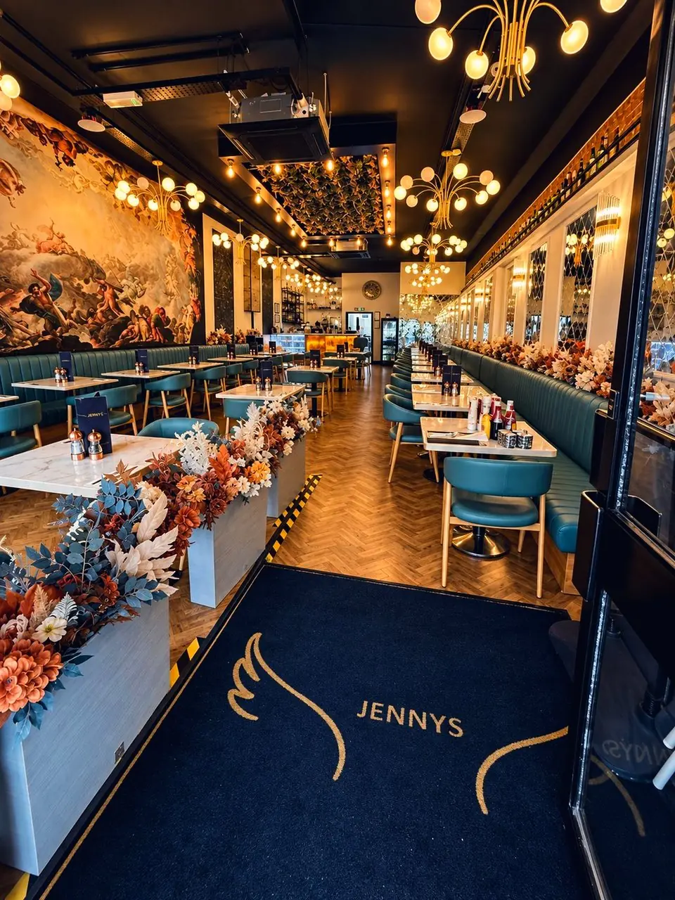The doormat with Jenny's gold wings, flowers either side