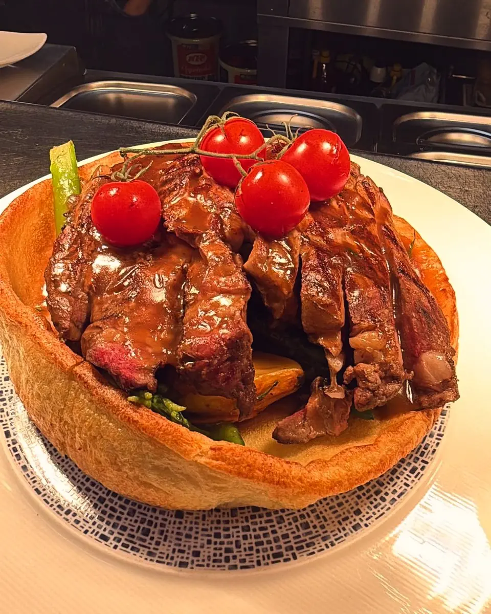Sliced beef with cherry tomatoes in a Yorkshire pudding